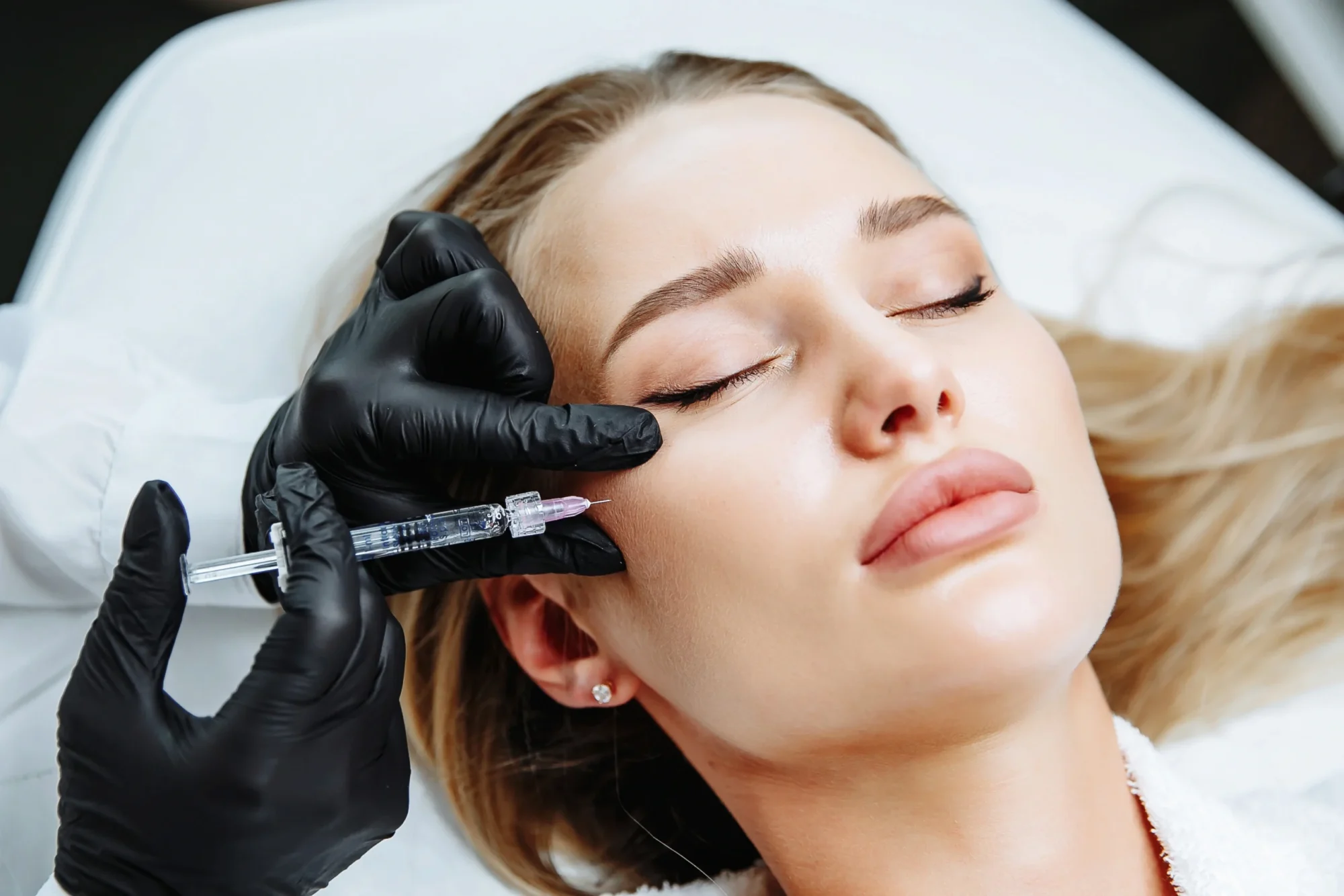 Woman getting injected with filler treatment | Renewal Aesthetics and Sexual Wellness | Sandy, UT